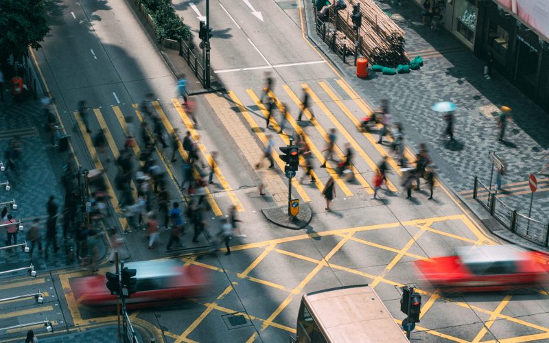 People and taxi cabs crossing a very busy crossroads in Tsim Sha Tsui district Hong Kong, China